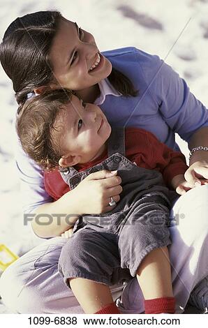 overhead, people, sitting, outdoors, cuddling, brunette, caring View Large Photo Image Stock Photo - overhead, people, sitting, outdoors, cuddling, brunette, caring. Fotosearch