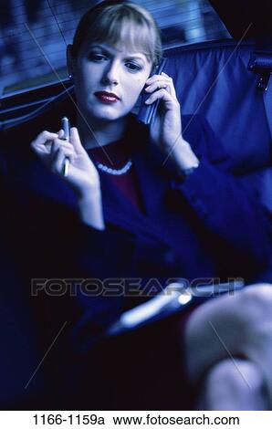 Stock Image - pen, woman, limousine, talking, conversation, car, phone. Fotosearch