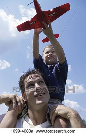 people, airplane, playing, flying, watch, holding, looking View Large Photo Image Stock Image - people, airplane, playing, flying, watch, holding, looking. Fotosearch