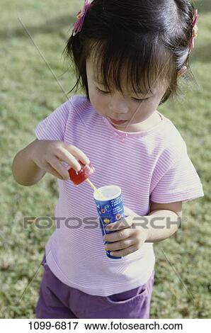 people, Asian, bottle, bubbles, girl, outdoors, blowing View Large Photo Image Stock Photo - people, Asian, bottle, bubbles, girl, outdoors, blowing. Fotosearch