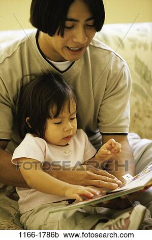 people, Asian, male, sitting, baby, reading, book View Large Photo Image Stock Image - people, Asian, male, sitting, baby, reading, book. Fotosearch