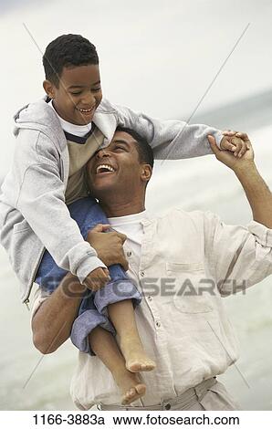 Stock Image - people, beach, carrying, family, father, shoulders. Fotosearch