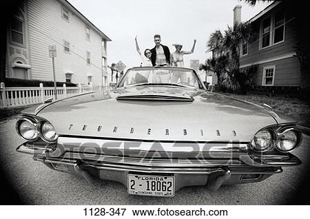 Stock Photo - people, car, houses, outdoors, transportation, friends, waving. Fotosearch
