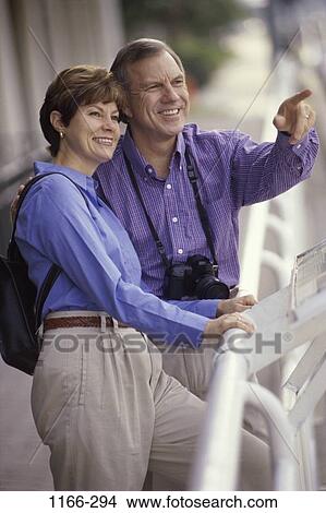 people, couple, backpack, pointing, outdoors, point, Middle-aged View Large Photo Image Picture - people, couple, backpack, pointing, outdoors, point, Middle-aged. Fotosearch