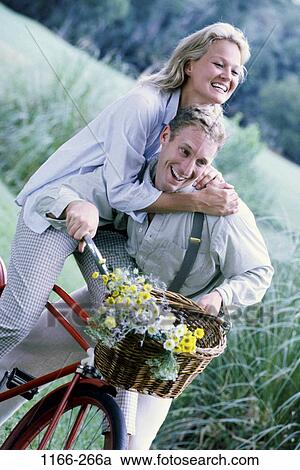 people, couple, bicycle, riding, flowers, basket, wheel View Large Photo Image Stock Image - people, couple, bicycle, riding, flowers, basket, wheel. Fotosearch