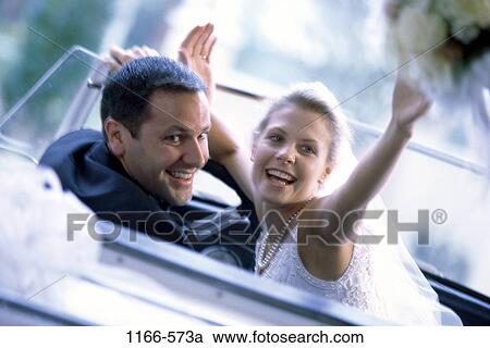 Stock Image - people, couple, car, driving, convertible, departure, outdoors. Fotosearch