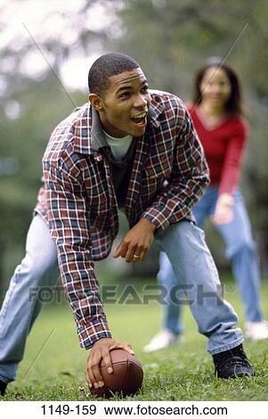 people, couple, football, outdoors, sports, quarterback, African-American View Large Photo Image Stock Photo - people, couple, football, outdoors, sports, quarterback, African-American. Fotosearch