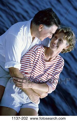 Stock Image - people, couple, happy, boat, Middle-aged, romance, embrace. Fotosearch
