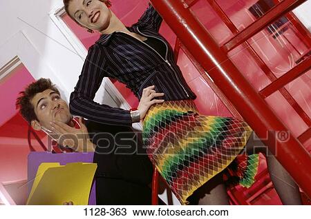 Stock Image - people, couple, Hispanic, flirting, business, friends, folders. Fotosearch