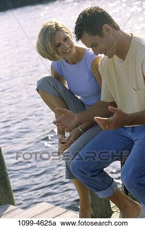 Stock Image - people, couple, lake, outdoors, dock, vacation, jeans. Fotosearch
