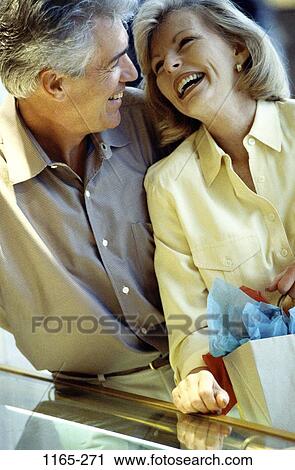 Stock Image - people, couple, laughing, Middle-aged, shopping, amused, happiness. Fotosearch