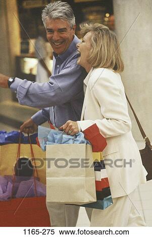 people, couple, laughing, outdoors, Middle-aged, shopping, amused View Large Photo Image Stock Photography - people, couple, laughing, outdoors, Middle-aged, shopping, amused. Fotosearch