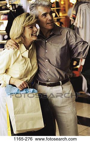 Stock Photograph - people, couple, Middle-aged, shopping, clothes, choosing, clothing. Fotosearch