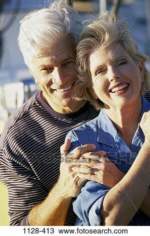 Stock Image - people, couple, senior, boating, outdoors, hugging, commitment. Fotosearch