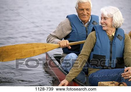 Stock Photo - people, couple, senior, lake, boating, outdoors, boat. Fotosearch