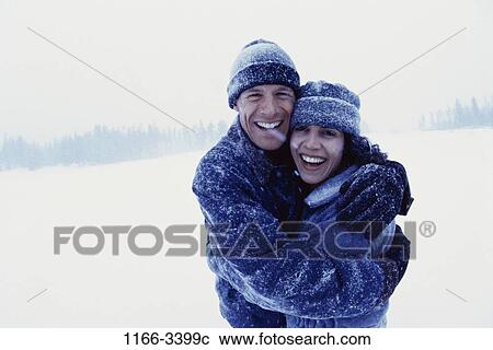 Stock Image - people, couple, winter, outdoors, young adult, Young couples outdoors winter. Fotosearch