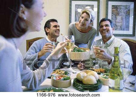 Stock Photograph - people, eating, party, table, toasting, wine, drinking. Fotosearch