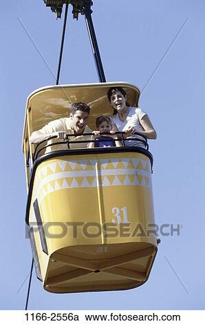 Stock Image - people, excitement, riding, amusement, entertainment, family. Fotosearch