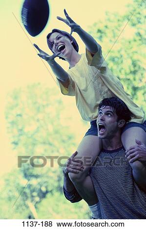 people, football, catching, sports, couples outdoors, carrying, joyous View Large Photo Image Stock Photo - people, football, catching, sports, couples outdoors, carrying, joyous. Fotosearch
