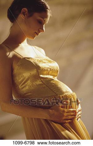 Stock Photo - people, gold, woman, eyes, daydreaming, dress, future. Fotosearch