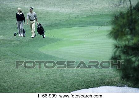 Stock Photo - people, green, walking, golf, couple, outdoors, sports. Fotosearch