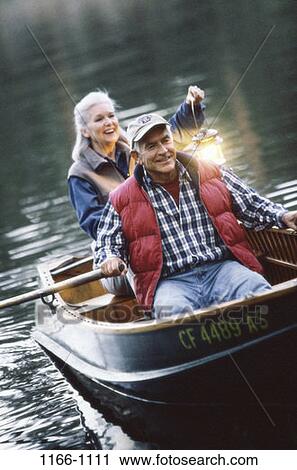 Stock Image - people, hat, couple, senior, lake, boating, outdoors. Fotosearch