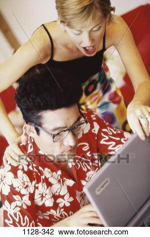 Stock Image - people, home, couple, technology, computer, laptop, grabbing. Fotosearch