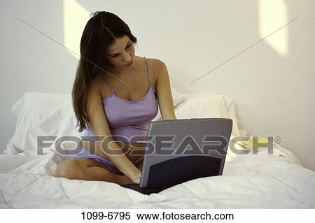 people, home, technology, sitting, computer, laptop, bed View Large Photo Image Stock Photography - people, home, technology, sitting, computer, laptop, bed. Fotosearch