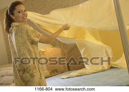 people, home, woman, bed, billowing, cleaning, spread View Large Photo Image Picture - people, home, woman, bed, billowing, cleaning, spread. Fotosearch
