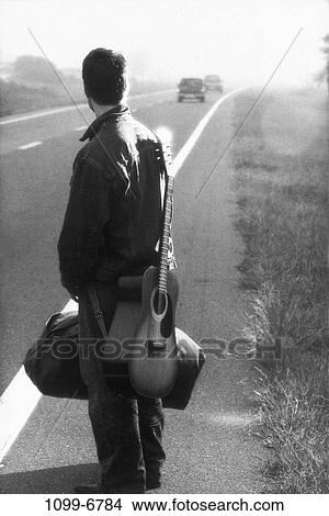 people, isolation, guitar, standing, outdoors, carrying View Large Photo Image Picture - people, isolation, guitar, standing, outdoors, carrying. Fotosearch