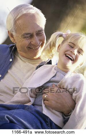 people, laughing, holding, outdoors, family, enjoying, enjoyment View Large Photo Image Stock Image - people, laughing, holding, outdoors, family, enjoying, enjoyment. Fotosearch