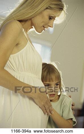 Stock Image - people, listening, mother, stomach, hugging, family, anticipation. Fotosearch