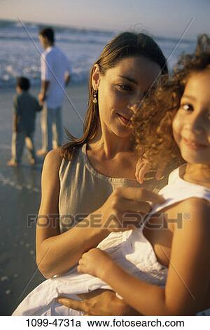 Stock Image - people, mother, Hispanic, beach, summer, outdoors, outings. Fotosearch