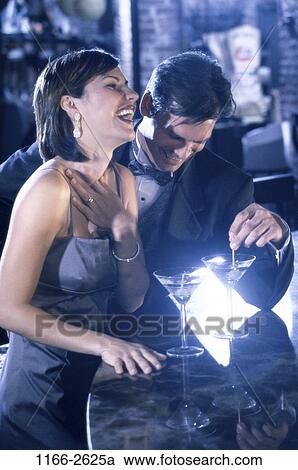 Stock Image - people, party, couple, drinking, laughing, flirting, bar. Fotosearch
