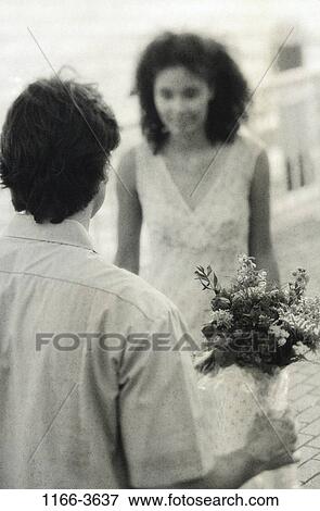 people, plants, couple, holding, flowers, young, outdoors View Large Photo Image Stock Photo - people, plants, couple, holding, flowers, young, outdoors. Fotosearch