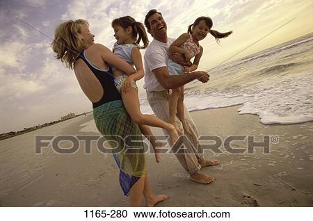 Stock Image - people, playing, beach, laughing, holding, playful. Fotosearch