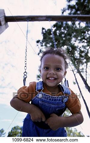Picture - people, playing, hanging, swinging, swing, playground, boy. Fotosearch