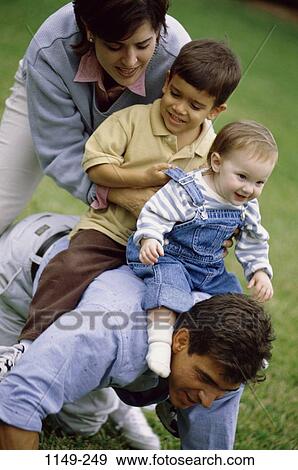 people, playing, Hispanic, riding, playful, outdoors, family View Large Photo Image Stock Photo - people, playing, Hispanic, riding, playful, outdoors, family. Fotosearch