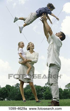 people, playing, watch, holding, outdoors, park, strength View Large Photo Image Stock Image - people, playing, watch, holding, outdoors, park, strength. Fotosearch