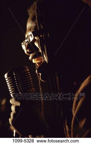 Stock Photo - people, profile, eyeglasses, arts, entertainment, singing. Fotosearch