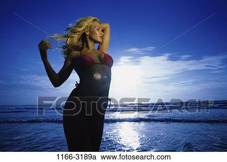 people, relaxation, woman, isolation, beach, bathing suit, individuality View Large Photo Image Stock Image - people, relaxation, woman, isolation, beach, bathing suit, individuality. Fotosearch