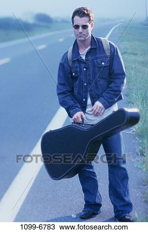 people, road, mist, sunglasses, guitar, outdoors View Large Photo Image Stock Image - people, road, mist, sunglasses, guitar, outdoors. Fotosearch