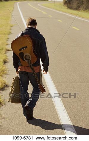 people, road, walking, guitar, back, outdoors View Large Photo Image Stock Image - people, road, walking, guitar, back, outdoors. Fotosearch