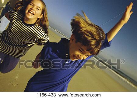 people, running, beach, children, brunette, Caucasian View Large Photo Image Stock Image - people, running, beach, children, brunette, Caucasian. Fotosearch