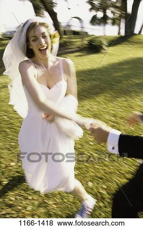 people, running, formal, couple, laughing, outdoors, wedding View Large Photo Image Stock Photo - people, running, formal, couple, laughing, outdoors, wedding. Fotosearch