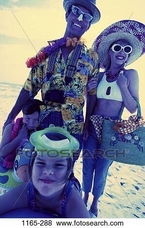 Stock Photo - people, smiling, beach, sunglasses, camera, smile, family. Fotosearch