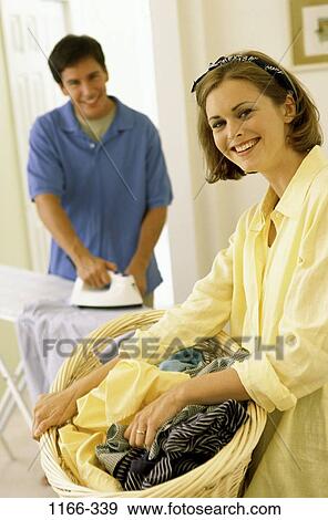 people, smiling, couple, basket, teamwork, iron, laundry View Large Photo Image Stock Photo - people, smiling, couple, basket, teamwork, iron, laundry. Fotosearch