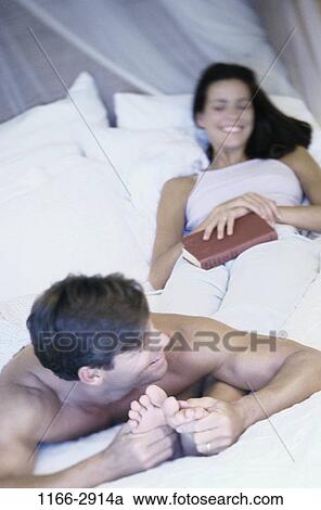 people, smiling, couple, bed, laughing, book, relaxing View Large Photo Image Stock Image - people, smiling, couple, bed, laughing, book, relaxing. Fotosearch