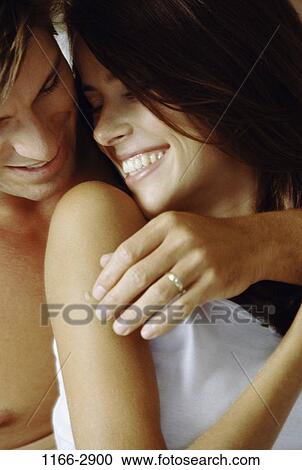 Stock Image - people, smiling, couple, laughing, romantic, hugging, joyous. Fotosearch