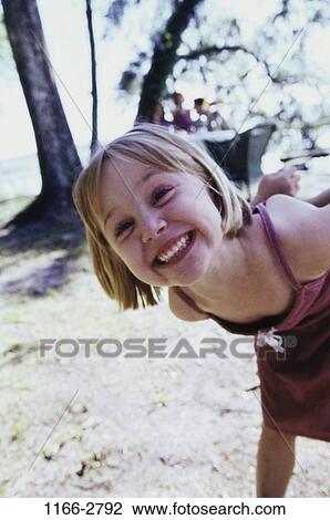 people, smiling, girl, leaning, trees, outdoors, smile View Large Photo Image Stock Image - people, smiling, girl, leaning, trees, outdoors, smile. Fotosearch